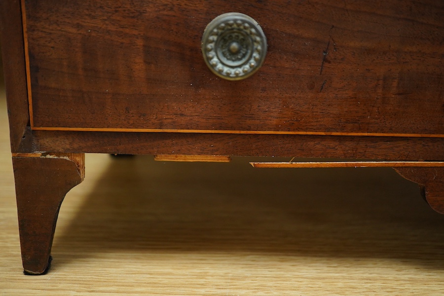 An early 20th century mahogany miniature chest of drawers, 39cm tall. Condition - one piece detached